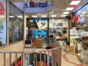 دو نفر درون مغازه‌ای در پاساژ بهارستان خیابان ملت نشسته‌اند